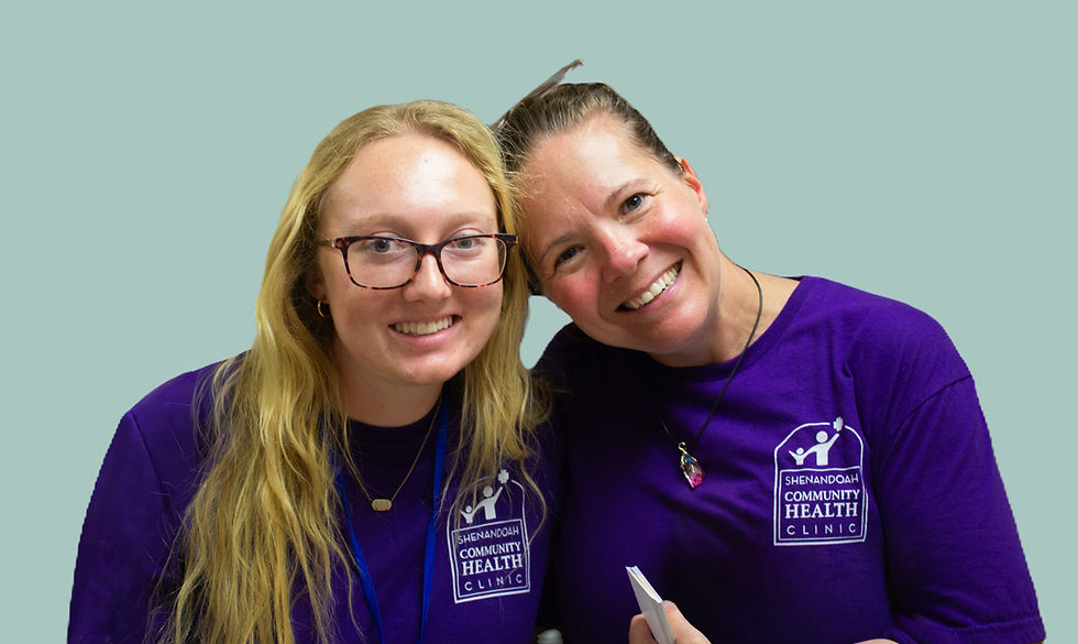 Two employees of the health clinic smile in a friendly embrace