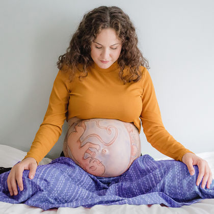 A Pregnant woman with a rebozo on her lap (C) Doula Lili