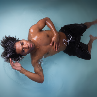 Man floating, wear a black swimsuit
