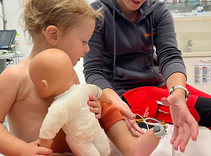 nurse-checking-baby-in-emergency-room-abroad-highlighting-travel-insurance-for-families.JP