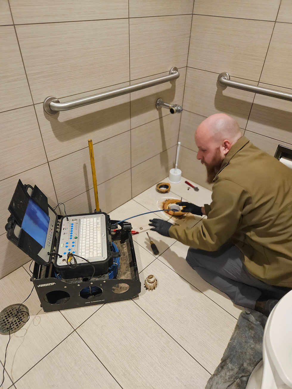 Eye-level view of a sewer camera reel and monitor setup ready for inspection