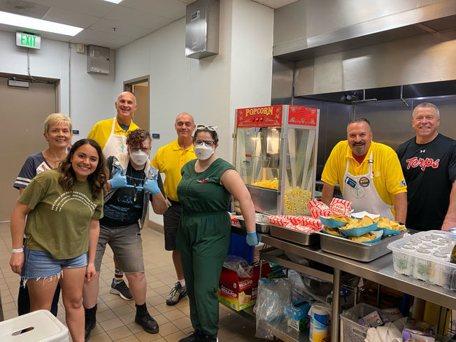 A group of people from Holy Name of Mary's "No Barriers to Christ" ministry serve food at a parish event.