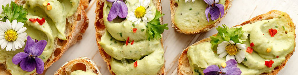 Vegetarian canapé crostini with fresh herbs and edible flowers