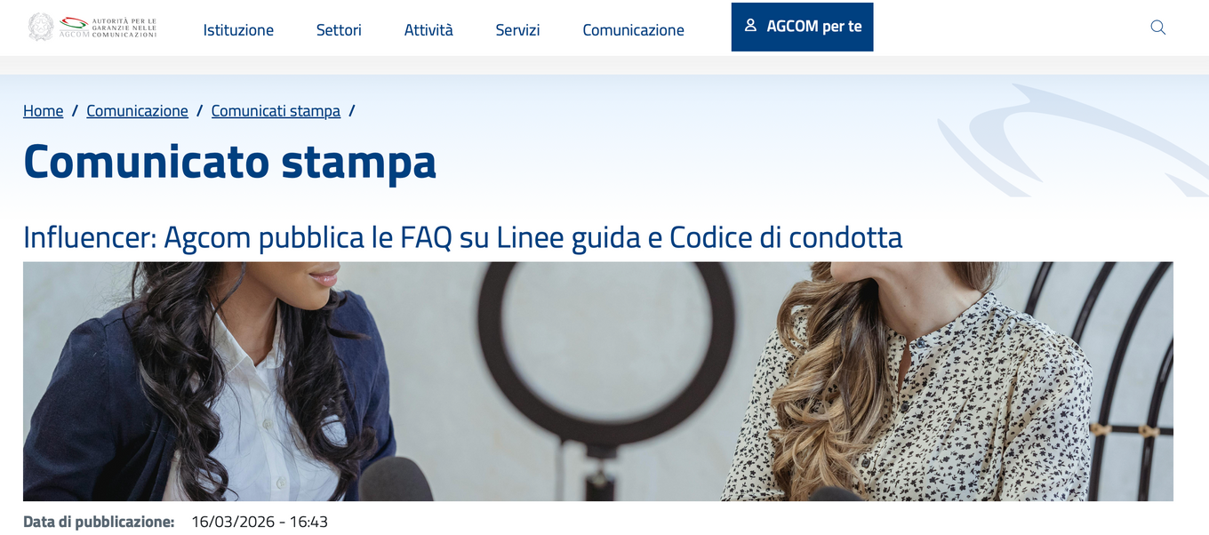 Women in a professional setting talking, with text on screen detailing AGCOM's influencer guidelines and conduct code release.