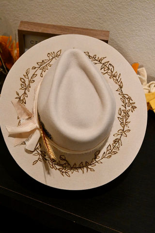 Handcrafted western hat with floral engraving and feather accent by LWx Custom Hats