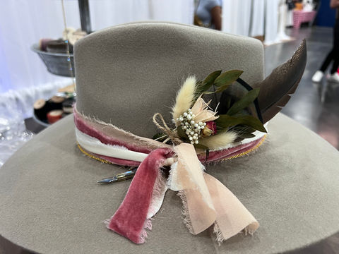 Close-up of custom western hat with feathers and velvet hatband accessories by LWx Custom Hats