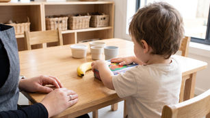 Preschool child independently opening a lunchbox at an The Green Elephant early learning centre, building school readiness Sydney skills