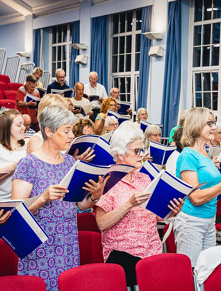 Otley Choral Society in rehearsal space with copies of Ethel Smyth's Mass in D