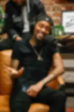 Man with a smile talking into a microphone