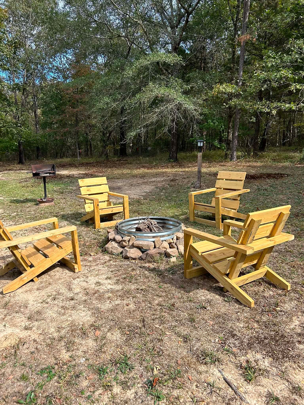 High angle view of a fire pit with chairs around it on a cabin deck