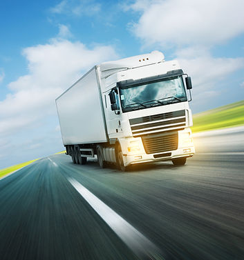 White truck on asphalt road under blue sky with clouds.jpg