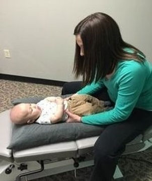 Dr. Alison adjusting a pediatric patient