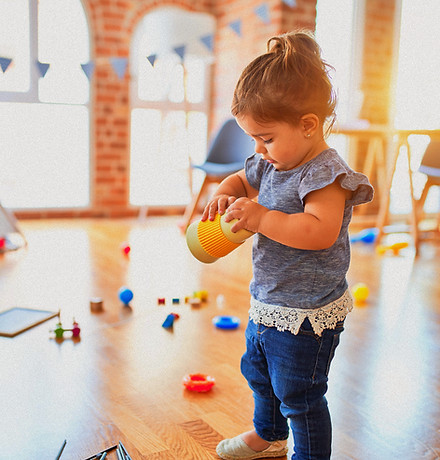 Beautiful toddler holding plastic glass