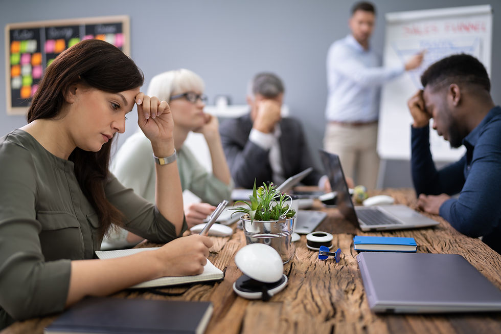Upset Businesspeople Sitting In Office While Their Colleague Giving Presentation.jpg