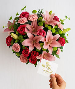 Heart-shaped floral arrangement: pink lilies, roses, carnations; Rose And Silk Florist