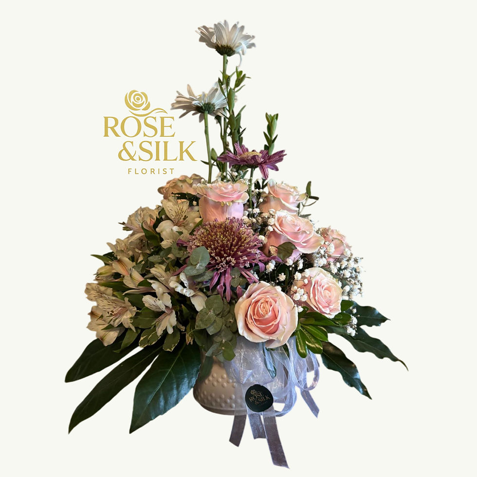 Elegant pink and white floral arrangement by Rose And Silk Florist
