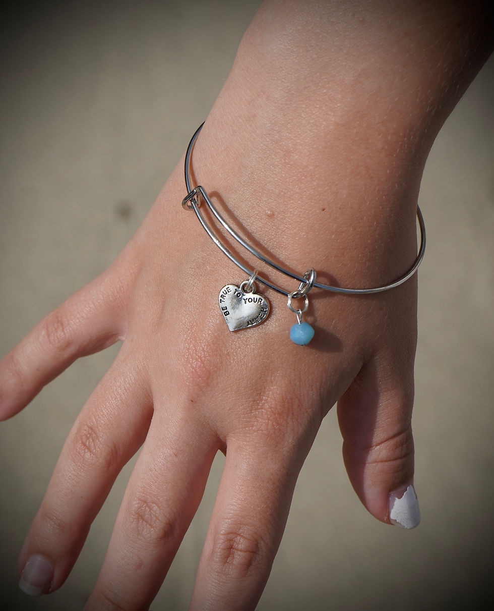 Custom silver bracelet with heart and blue charm