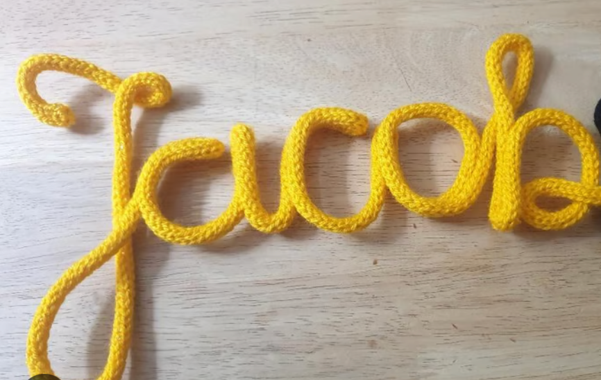 Yellow crochet wire art spelling 'Jacob'