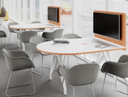 Conference room setup with tables, chairs, and large monitor screens in place.