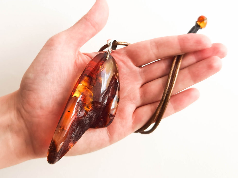 Thumbnail: Dark cognac/light cherry massive tusk shape natural amber pendant on leather
