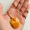 Thumbnail: Matt yellow color natural amber pendant on leather strand with natural hole