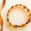 Thumbnail: Intense cognac color flat round beads natural amber bracelet