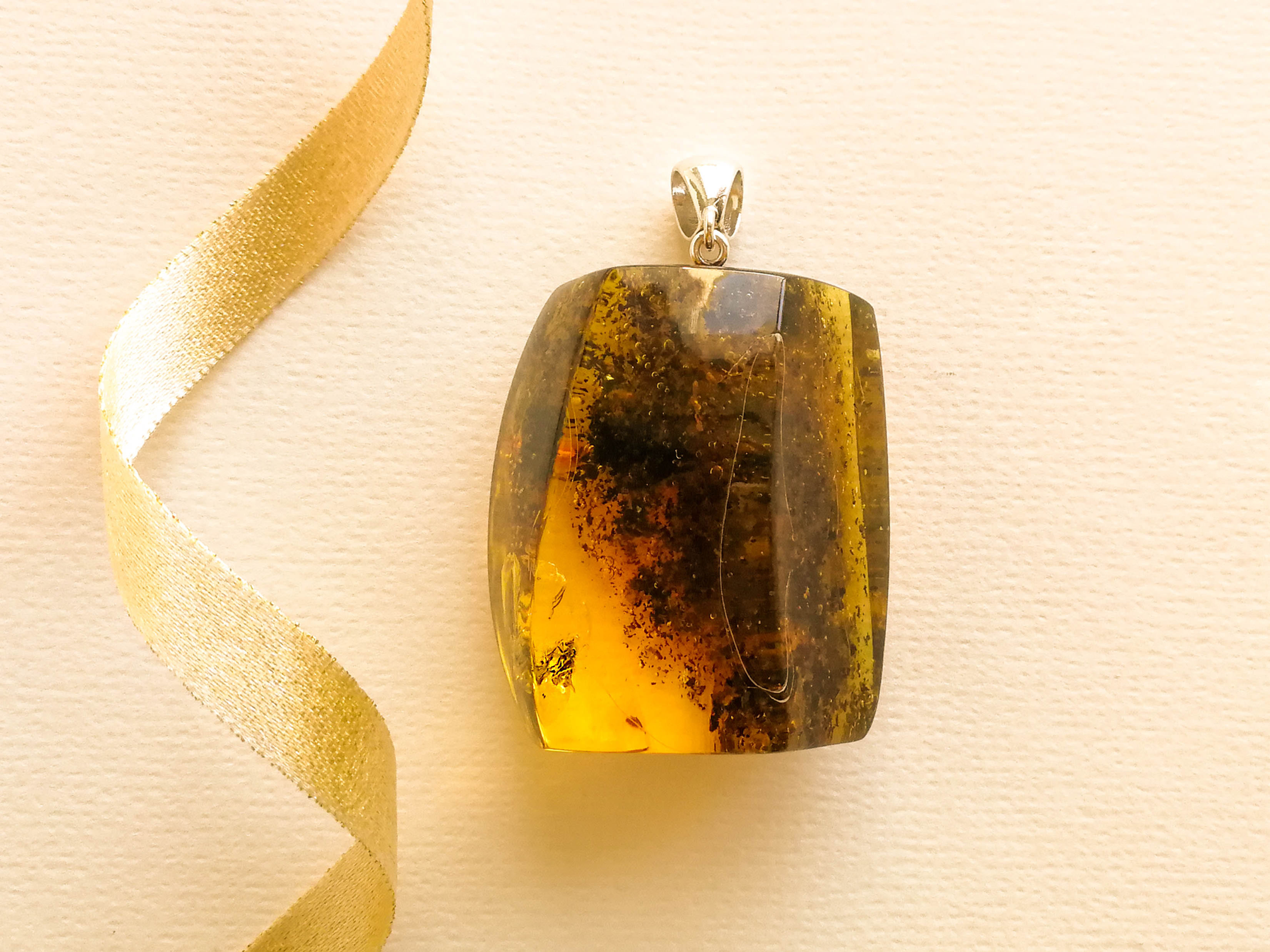 Not treated with heat large rectangular amber pendant with fly inside