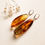 Thumbnail: Natural drop shape Baltic amber earrings in unique cognac color