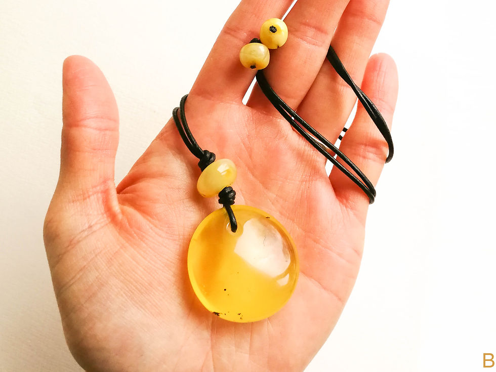 Thumbnail: Small matt yellow color amber donut pendant necklace on leather strand