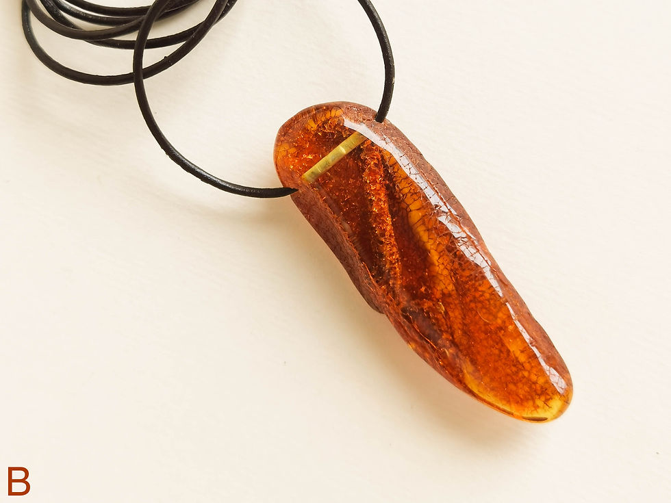Thumbnail: Light cognac color amber tusk pendant with genuine leather strand