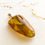 Thumbnail: Not heated triangle shape natural amber yellow pendant with skin