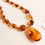 Thumbnail: Natural amber bright cognac color shiny oval pendant necklace