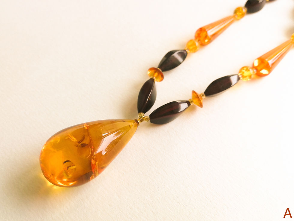 Thumbnail: Natural amber cognac color drop pendant on a cherry color necklace