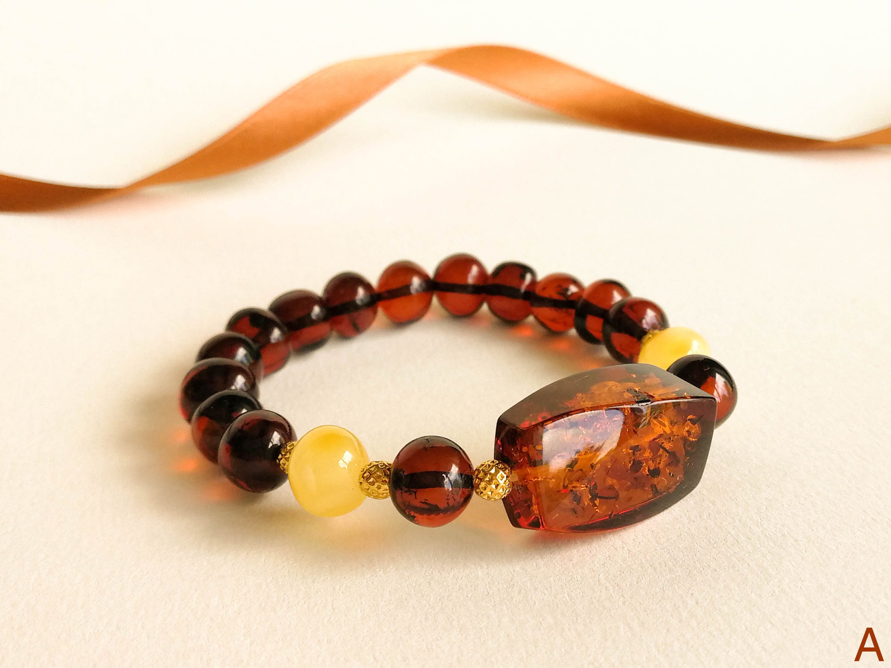 Dark cognac and cherry beads natural amber bracelet with center stone