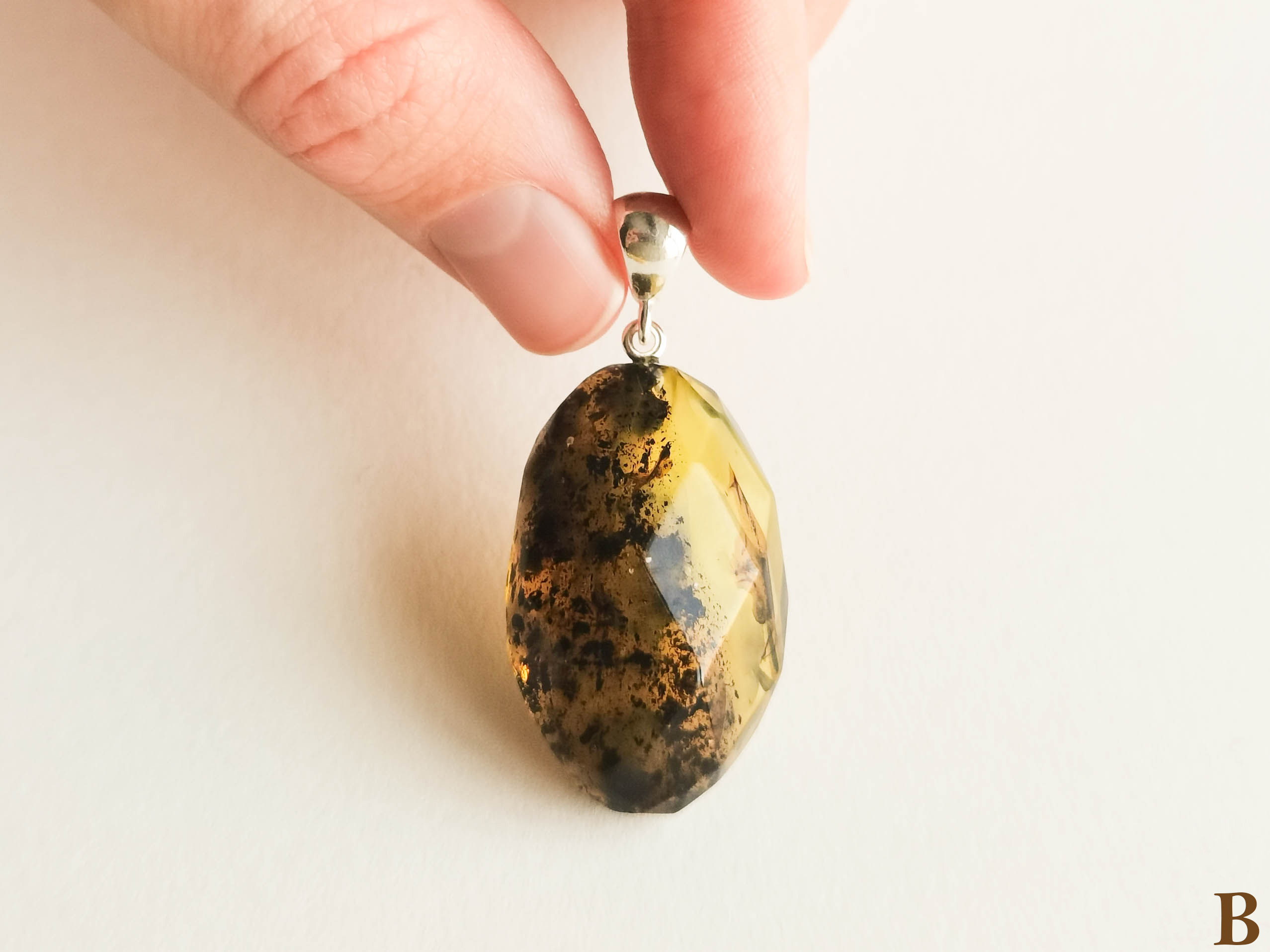 Natural Baltic amber light and dark green colors faceted oval pendant