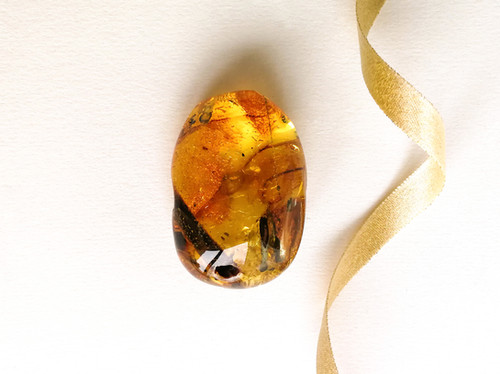 Natural amber thick oval shape light cognac color souvenir stone