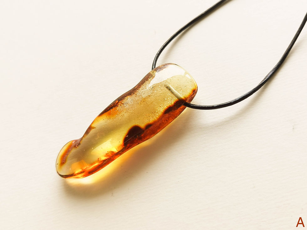 Thumbnail: Light cognac color amber tusk pendant with genuine leather strand