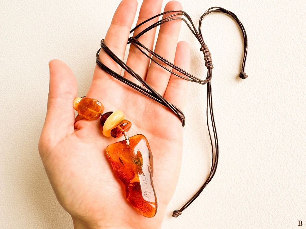 Thumbnail: Cognac and orange colors drop shape amber pendant on adjustable necklace