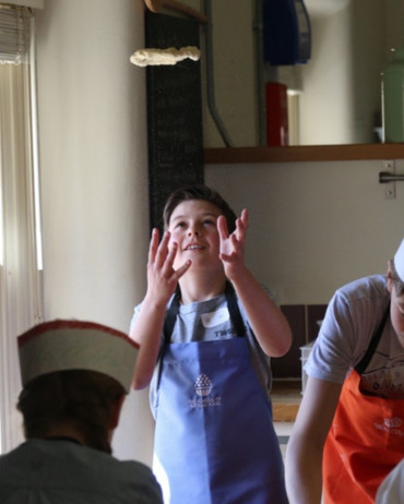 Pupils cooking food in a cookery class