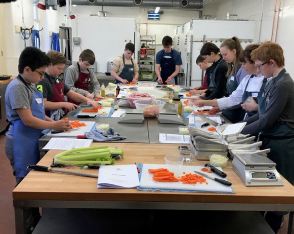 Pupils cooking food in a cookery class