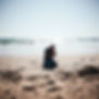 man on the ground praying on the beach.jpg