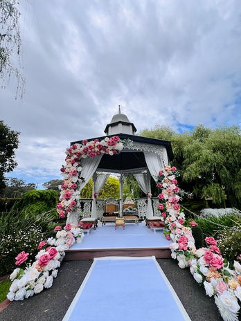 Elevate your wedding or event with stunning floral gazebo décor by Bandhan Events Our beautifully designed gazebos are adorned with lush, intricate floral arrangements, creating a romantic and enchanting ambiance. Perfect for outdoor ceremonies or as a striking centerpiece, these gazebos can also be seamlessly transformed into mandaps for traditional weddings. With bespoke options available, we tailor every detail to match your vision, incorporating your chosen colors, themes, and style. Whether you desire classic elegance or a modern twist, our floral gazebo décor promises to leave a lasting impression, making your special day truly unforgettable.