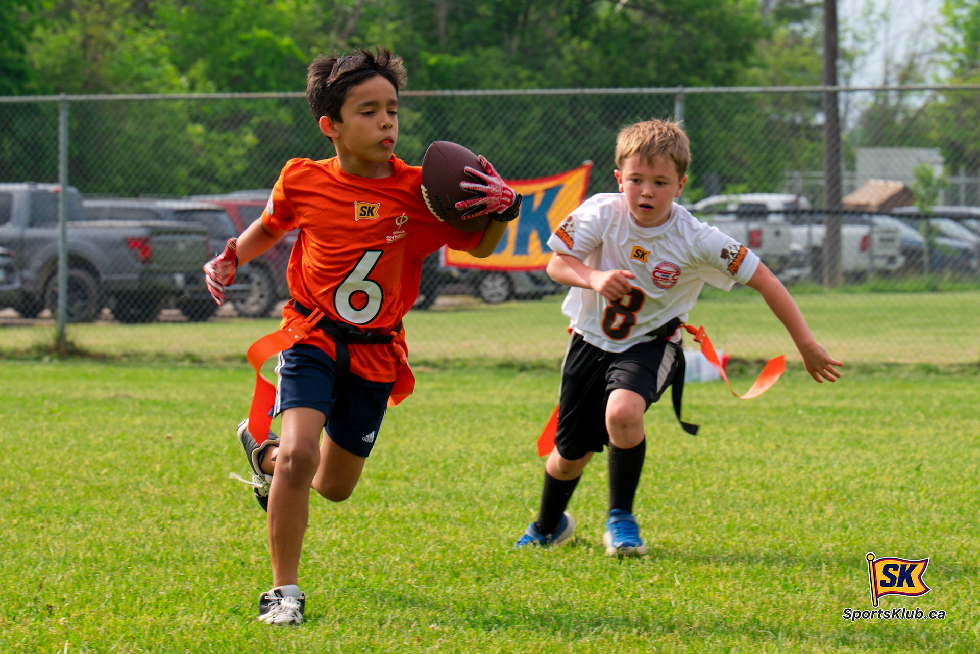 Aaron Kotekar of Orillia Synergy Healthcare runs past Hank Clarke of Cordery Electric during Ramara 
