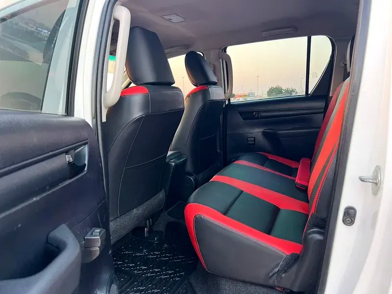 Miniature : Intérieur de voiture, sièges arrière noirs et rouges, spacieux et modernes.