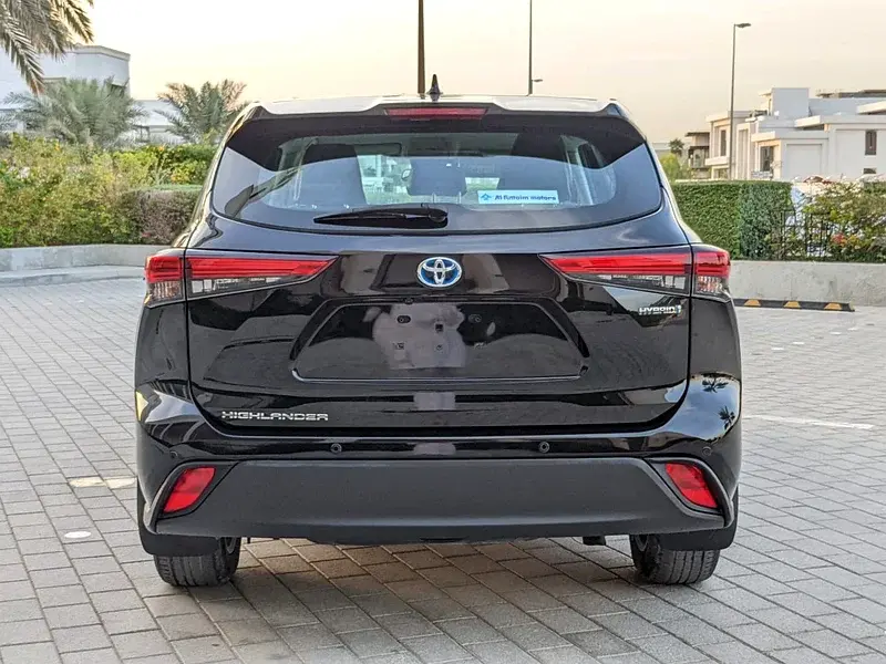 Miniature : Arrière d'un SUV noir TOYOTA HIGHLANDER HYBRID garé sur pavé.