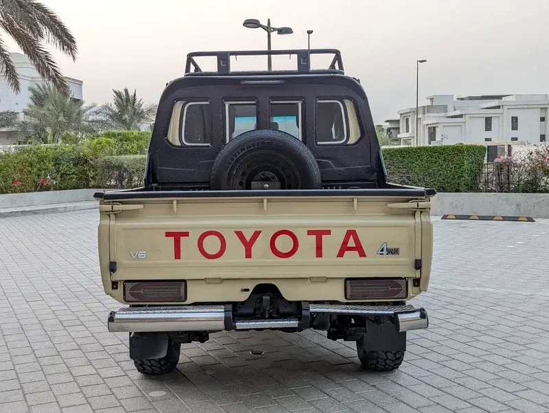 Miniature : Pick-up Toyota beige, texte "TOYOTA" et "V6", vue arrière.