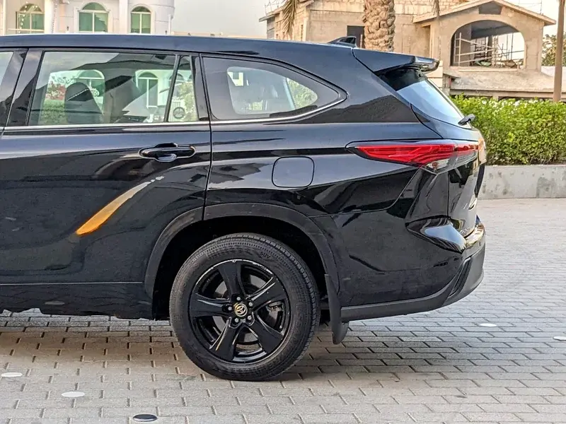 Miniature : SUV noir brillant, vue latérale arrière avec jantes noires, accent doré.