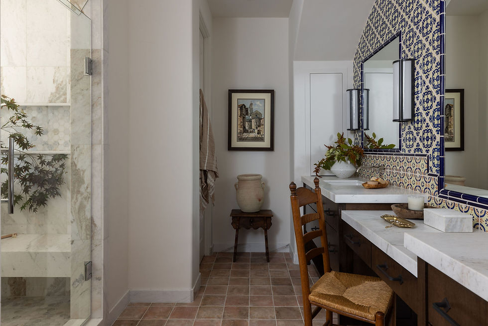 Bathroom featuring custom tile detailing, marble countertops, warm wood cabinetry, and collected European-inspired styling.
