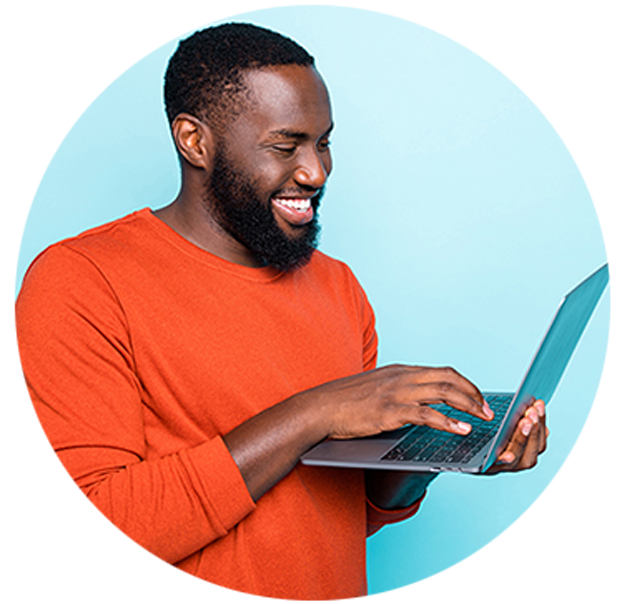 Black male typing on his hand-held laptop.laptop.