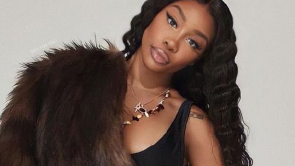After months of playful teases, cryptic selfies, and eagle-eyed fans speculating across social media, SZA is finally ready to let us in on her long-kept beauty secret—and it’s been hiding in plain sight the entire time: her lips.  This week, the Grammy-winning singer and style icon unveiled her newest collaboration with a major beauty brand, debuting a signature lip product she’s quietly been wearing for months. The reveal came via an effortlessly cool campaign video posted to her Instagram, where SZA is seen applying the exact shade fans have been obsessing over, accompanied by a caption that simply read, “It’s time.”